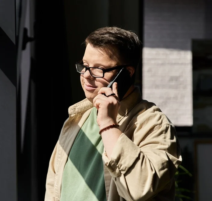 Portrait of a down syndrome boy talking on the phone